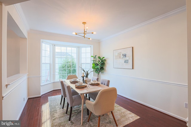 dining area with dark hardwood / wood-style flooring, crown molding, and a notable chandelier