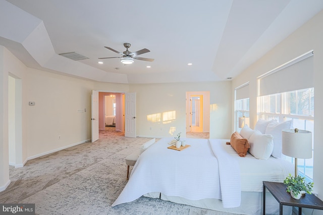 bedroom featuring ceiling fan and a raised ceiling