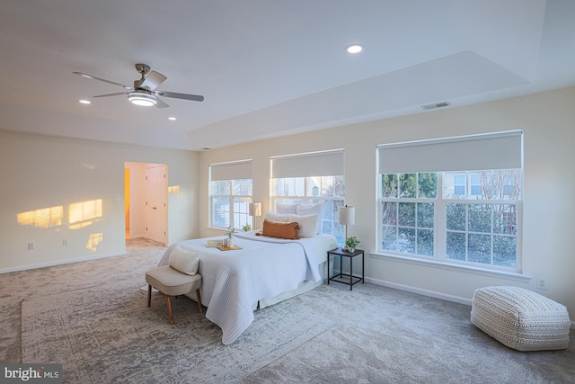 bedroom featuring ceiling fan, carpet floors, and multiple windows