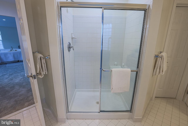 bathroom with walk in shower and tile patterned flooring