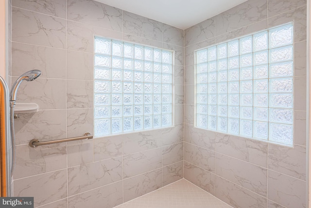 bathroom with a tile shower