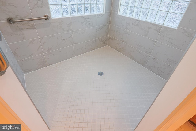 bathroom with tiled shower