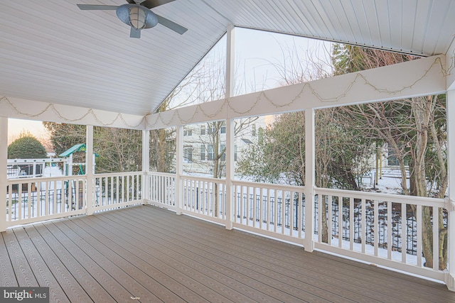 wooden terrace with a playground and ceiling fan