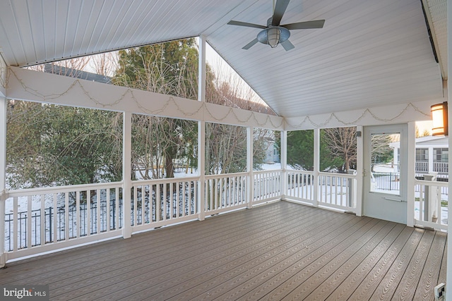 unfurnished sunroom featuring ceiling fan and vaulted ceiling