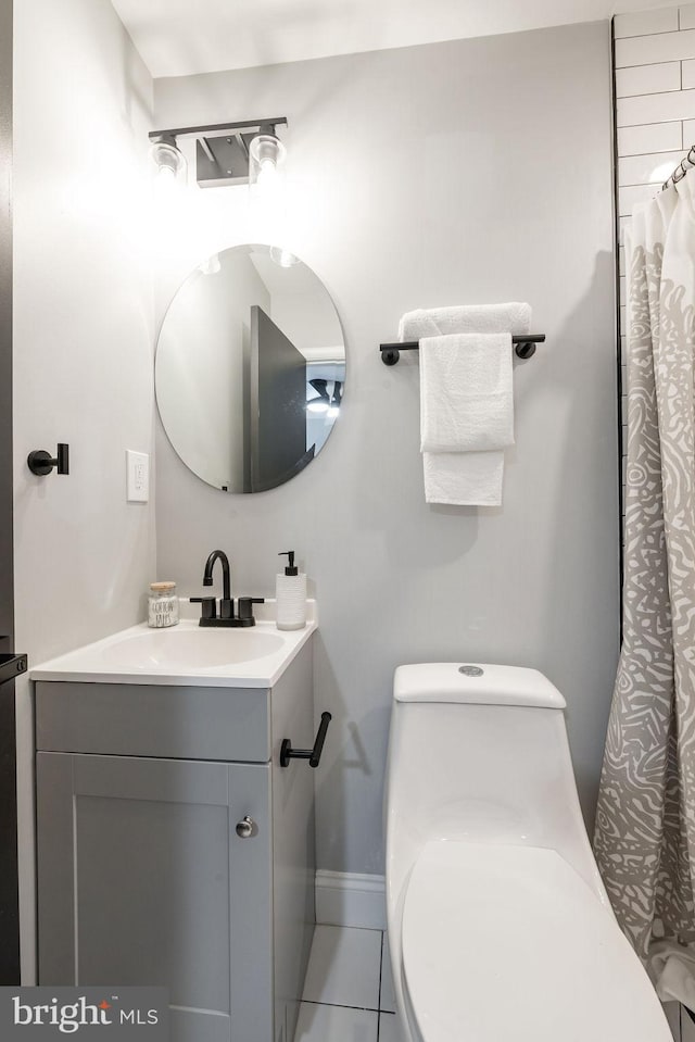 bathroom featuring a shower with curtain, tile patterned flooring, vanity, and toilet