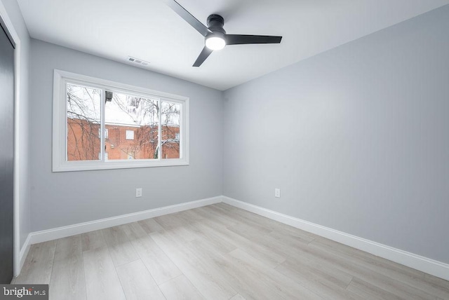 spare room featuring light hardwood / wood-style flooring and ceiling fan