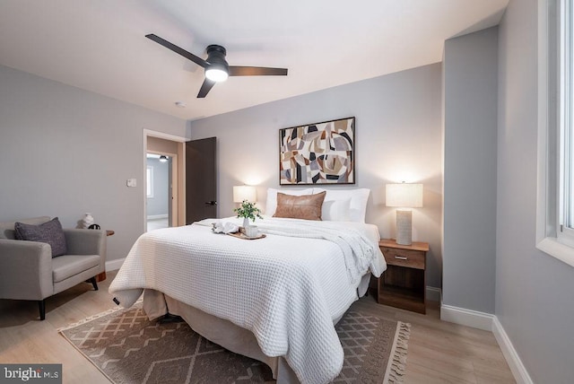 bedroom with light hardwood / wood-style flooring and ceiling fan