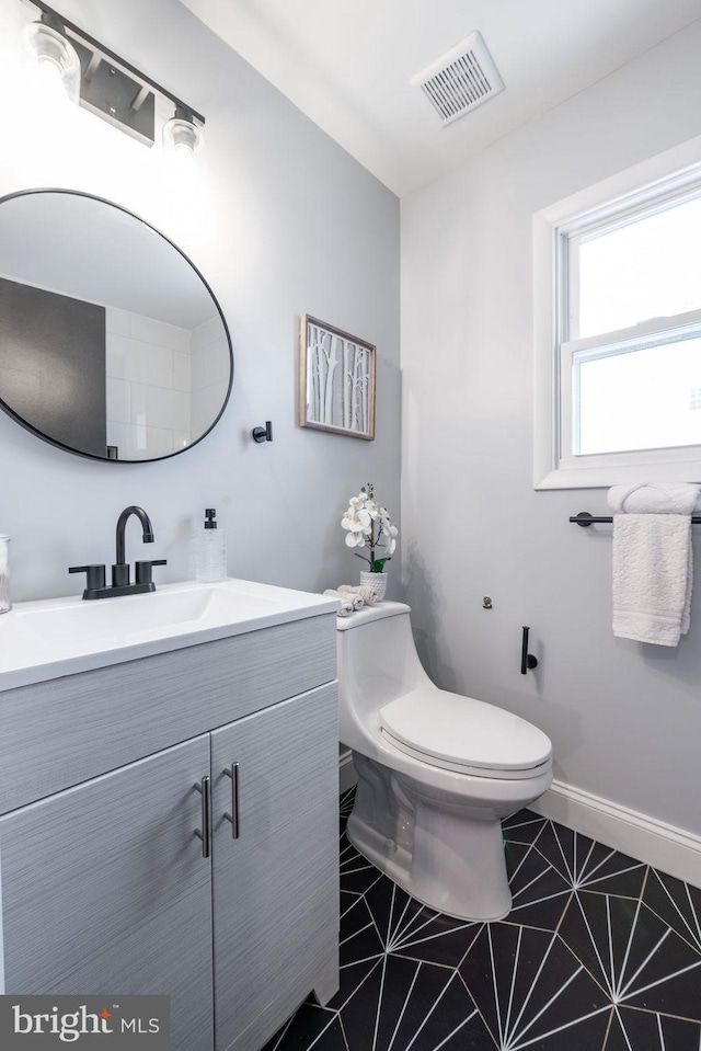 bathroom featuring tile patterned floors, vanity, and toilet