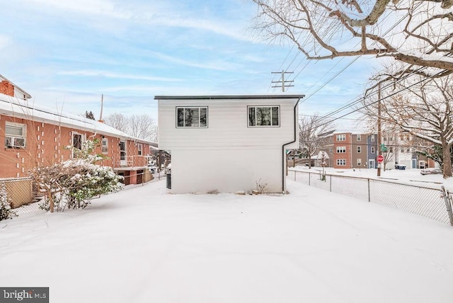 view of snow covered back of property