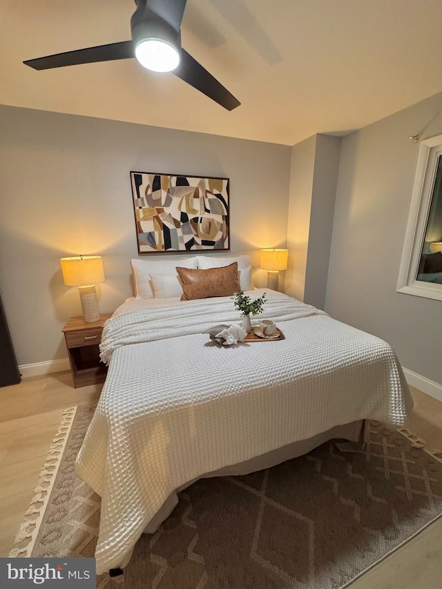 bedroom with ceiling fan and light hardwood / wood-style floors