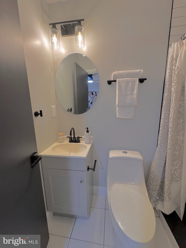 bathroom with tile patterned flooring, vanity, and toilet