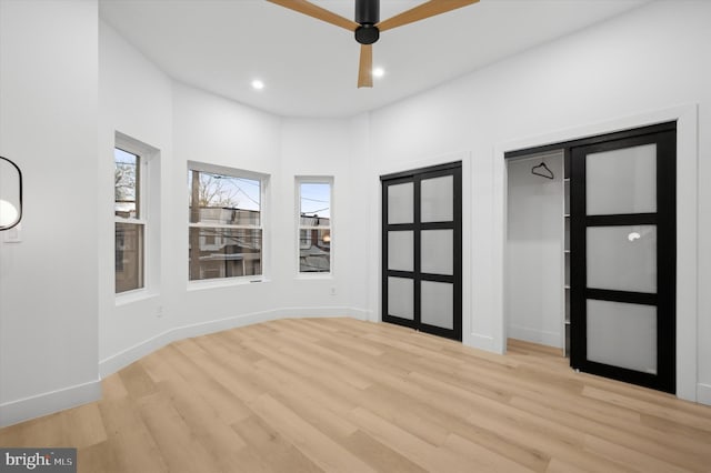 unfurnished room with ceiling fan and light hardwood / wood-style floors