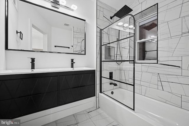 bathroom with vanity and tiled shower / bath