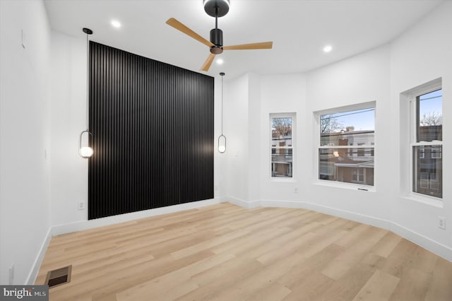 empty room featuring light hardwood / wood-style flooring and ceiling fan