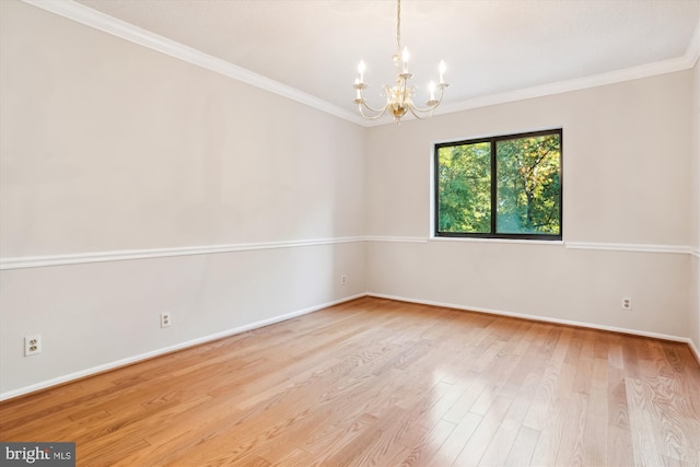 unfurnished room with light wood-type flooring, an inviting chandelier, and ornamental molding