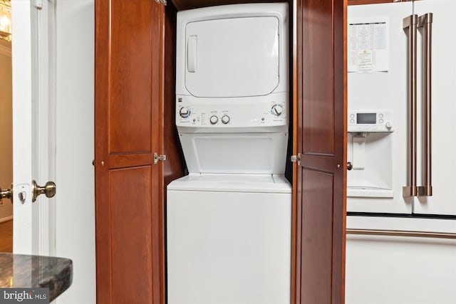 clothes washing area featuring stacked washer / dryer