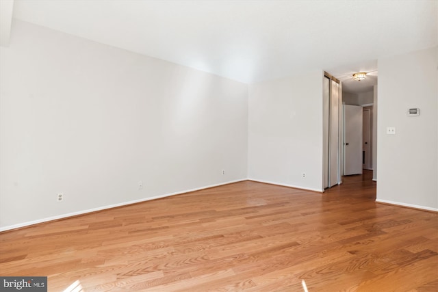 spare room with light hardwood / wood-style flooring