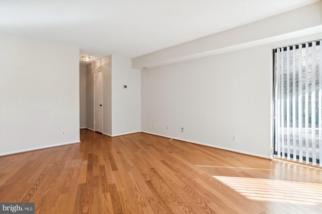 empty room with light hardwood / wood-style flooring