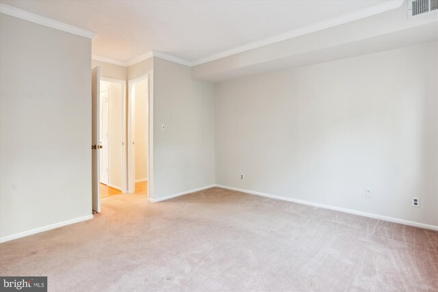 carpeted spare room with ornamental molding