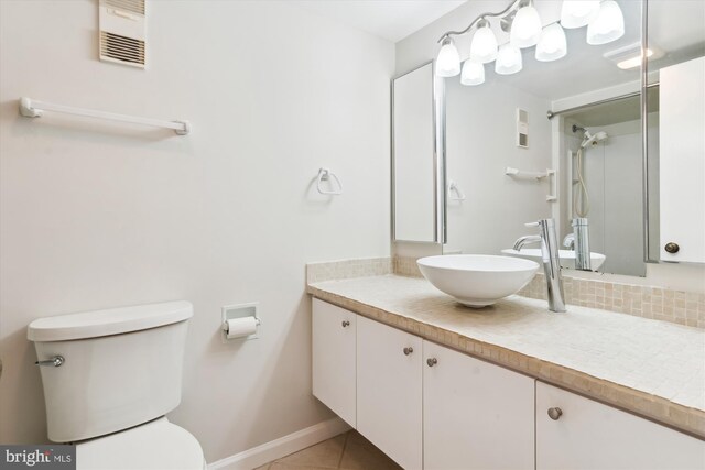 bathroom with tile patterned floors, vanity, and toilet