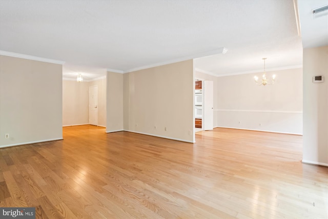 unfurnished room with crown molding, a chandelier, and light hardwood / wood-style floors