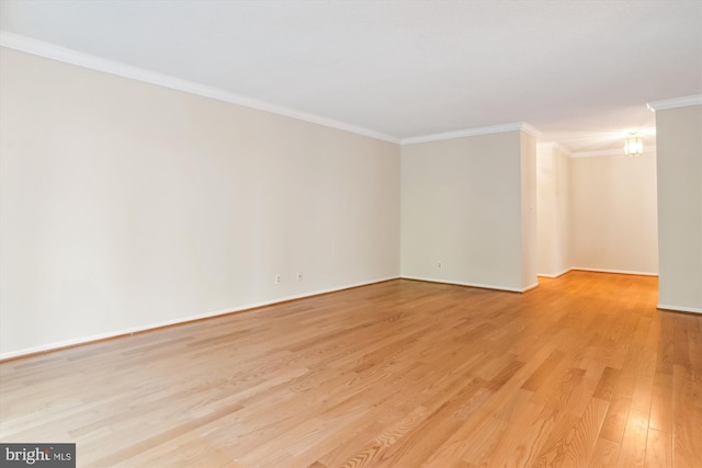 unfurnished room featuring light wood-type flooring and ornamental molding