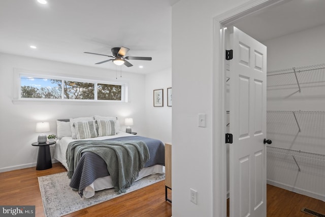 bedroom with ceiling fan and hardwood / wood-style flooring