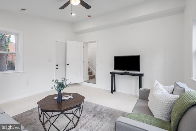 living room with ceiling fan and light carpet