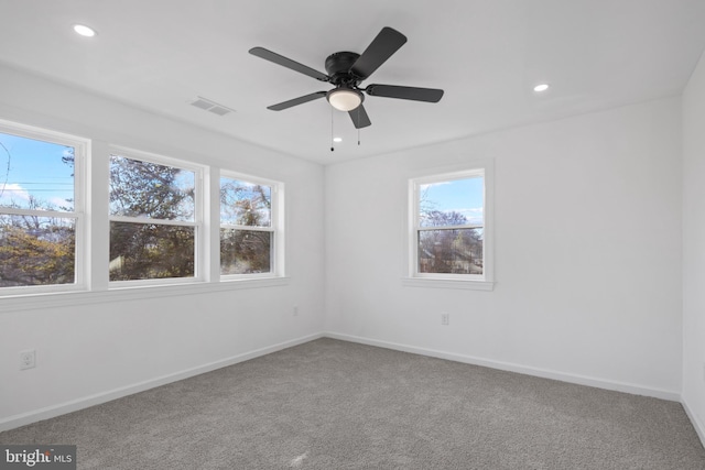 spare room featuring ceiling fan and carpet floors