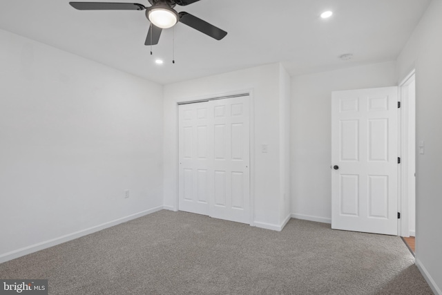 unfurnished bedroom featuring ceiling fan, a closet, and carpet