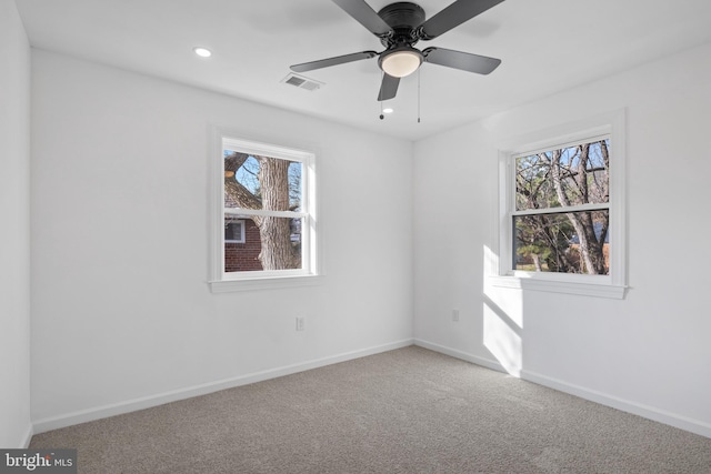 carpeted empty room featuring ceiling fan