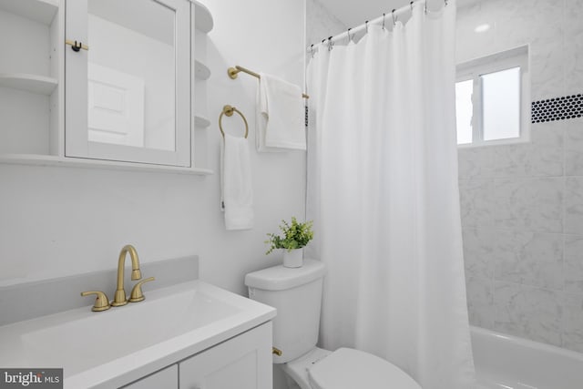 full bathroom with vanity, toilet, and shower / bath combo with shower curtain