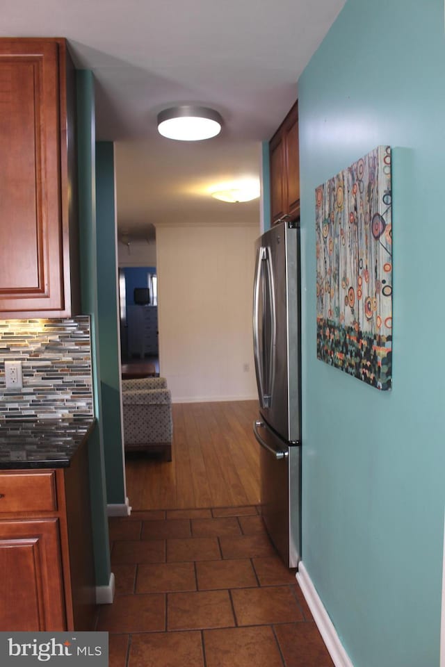 kitchen with tasteful backsplash and stainless steel refrigerator