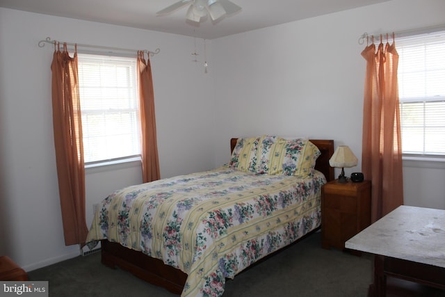 carpeted bedroom with ceiling fan and multiple windows