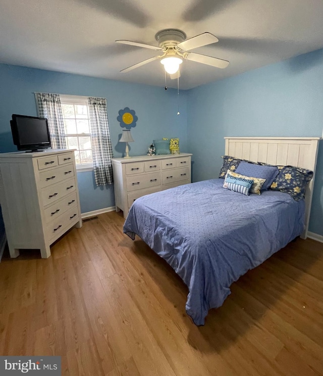 bedroom with light wood-type flooring and ceiling fan