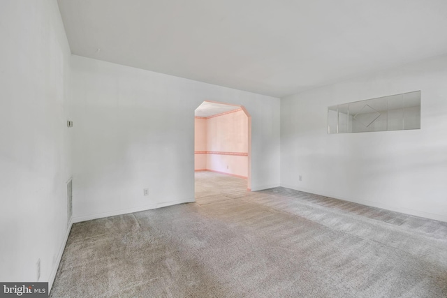 unfurnished room with light colored carpet