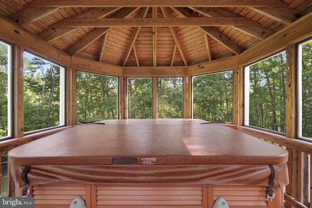 unfurnished sunroom featuring lofted ceiling with beams, wooden ceiling, and a jacuzzi