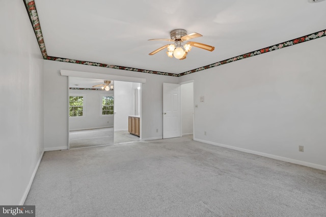 unfurnished room with ceiling fan and light colored carpet