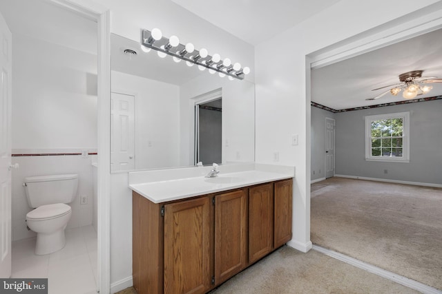 bathroom featuring vanity, toilet, and ceiling fan