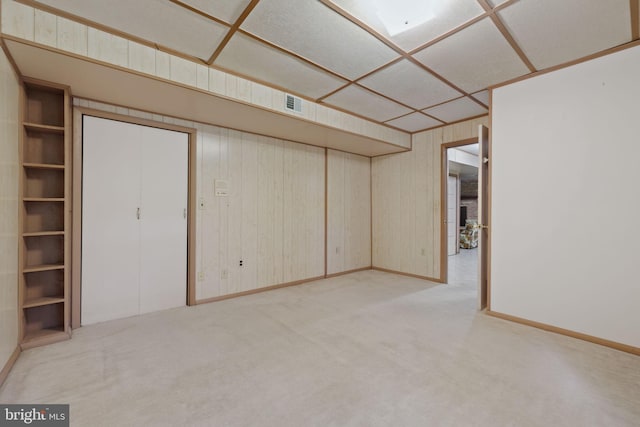 basement featuring light colored carpet