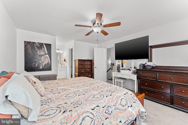 bedroom with ensuite bath, ceiling fan, and carpet floors