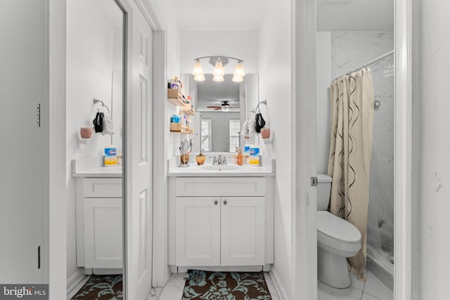 bathroom featuring ceiling fan, toilet, vanity, and walk in shower