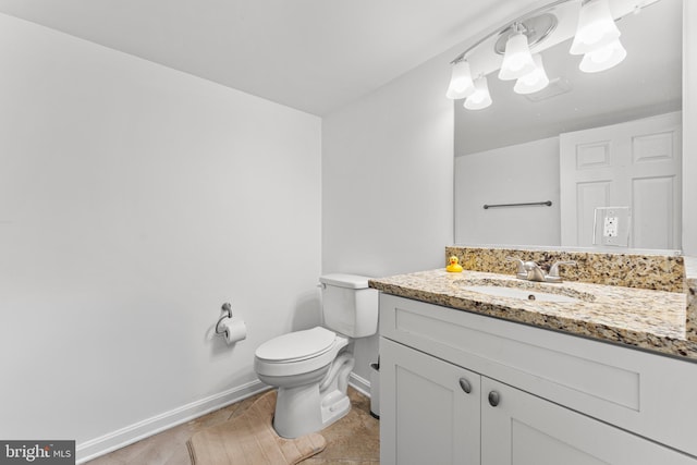 bathroom featuring tile patterned flooring, vanity, and toilet