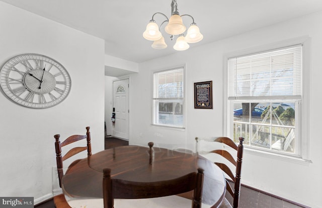 dining room with plenty of natural light and a notable chandelier