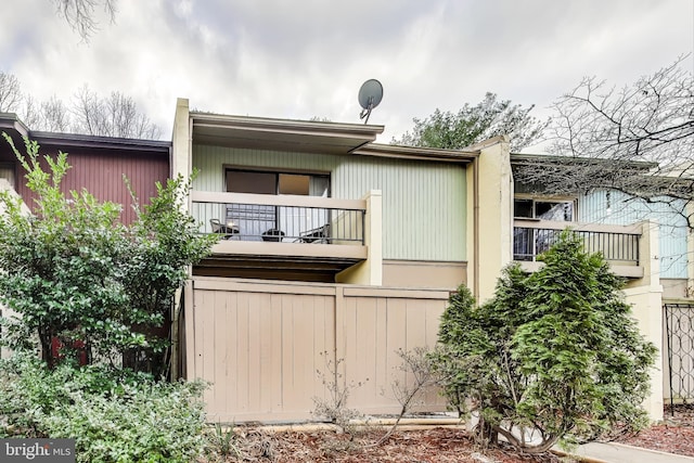 rear view of property with a balcony