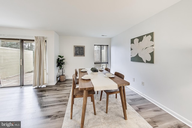 dining area with wood-type flooring