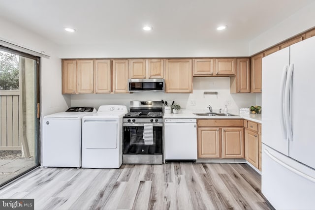 kitchen featuring washer and dryer, sink, light hardwood / wood-style floors, stainless steel appliances, and light brown cabinets