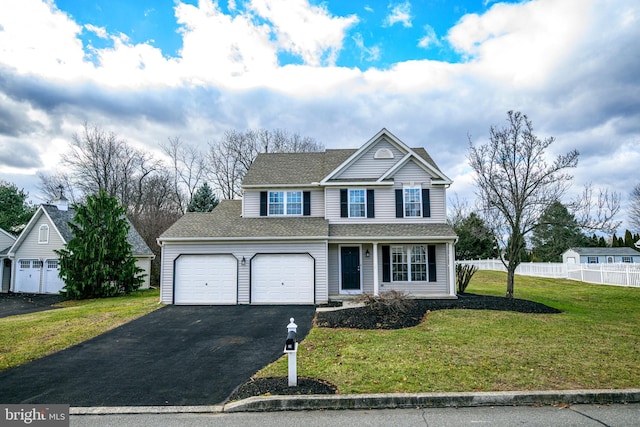 front of property featuring a front lawn and a garage