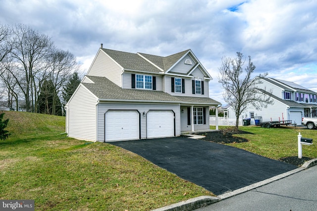 view of front of house featuring a front yard and a garage