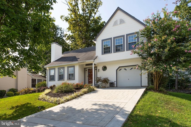 front of property featuring a front yard and a garage